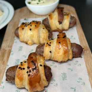 a tray of sausage wrapped in bread
