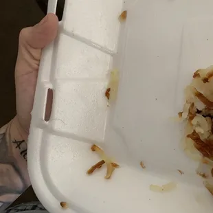 a half eaten sandwich in a styrofoam container
