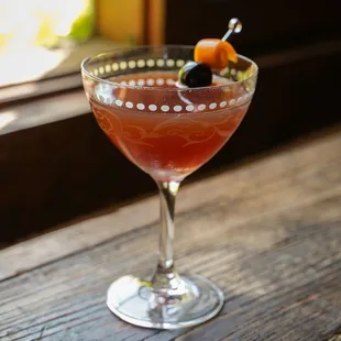 a cocktail in a wine glass