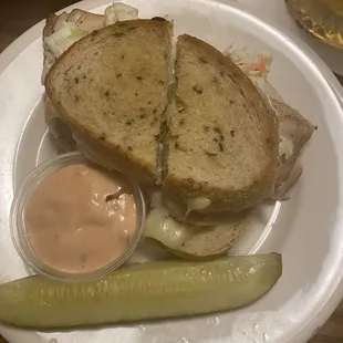 My palm sized turkey Ruben on a lunch plate . That is a standard gherkin, it's bigger than the 14.00 snack