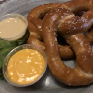 a plate of pretzels and mustard