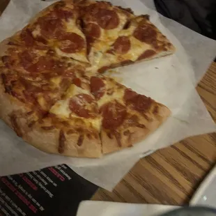 a pepperoni pizza with a slice missing