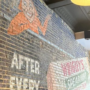 Old advertisement on the inside brick wall.
