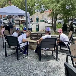 Outdoor seating, fire pit, dog area.