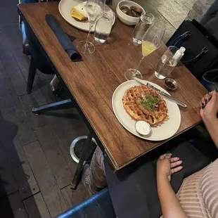 a woman sitting at a table with a plate of food