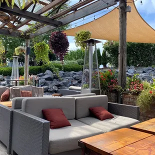 a patio with a couch and tables