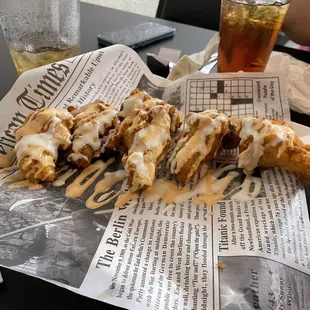 a half eaten pastry on a newspaper