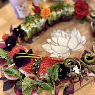 sushi rolls are arranged in a GORGEOUS platter, work of art