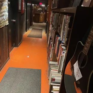 Books &amp; guitar for sale in the hallway
