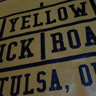 a yellow brick road sign
