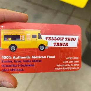 a hand holding a business card