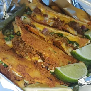 Delicious quesa tacos($3/each) - 3 birria on left/ 1 pastor far right