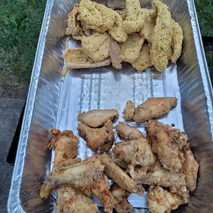 Catering event platter with Fresh Fried Fish &amp; Chicken seasoned with Thea's Bass and Biddy Kitchen' s signature seasonings and breading.
