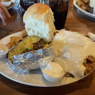 Chicken fried steak with fried corn nuggets and loaded baked potato