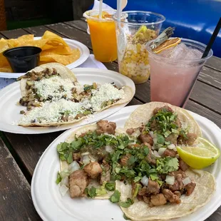 Barbacoa Tacos &amp; Veggie Tacos Platters with Elote Cup + Chips &amp; Salsa. Drinks are The Sage and a virgin frozen mango margarita.