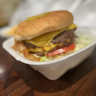 a hamburger in a styrofoam container
