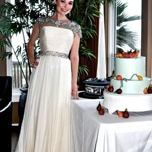 a woman standing in front of a cake
