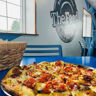 a pizza sitting on a blue table