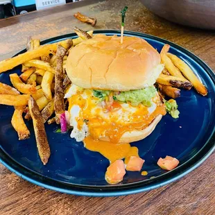a burger and fries on a blue plate