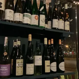 a shelf of wine bottles