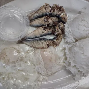 Fish with rice and two eggs over easy