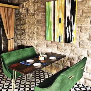 Thoughtfully curated space with comfortable touches, featuring local art and custom tables by Leanne Henry Wright