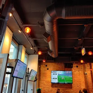 a group of people watching television in a restaurant