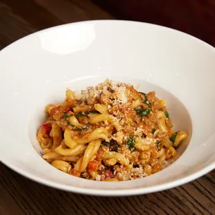 a pasta dish in a white bowl