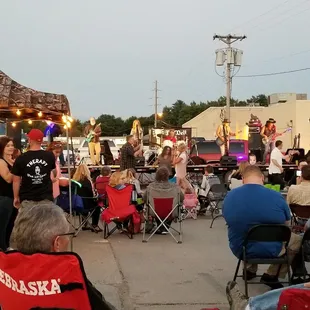 a group of people sitting in lawn chairs