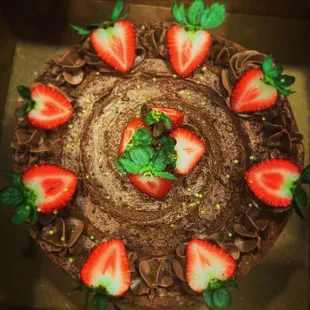 a chocolate cake with strawberries on top