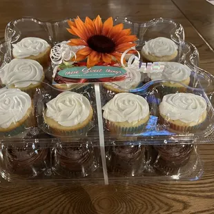a tray of cupcakes with frosting