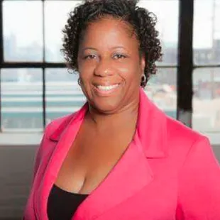 a woman in a pink blazer