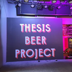 a neon sign that reads thesis beer project