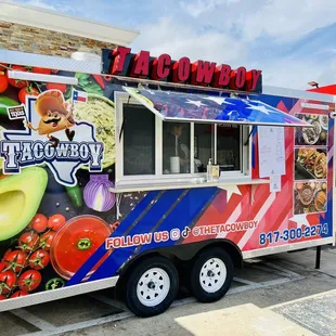 a taco truck parked in front of a restaurant