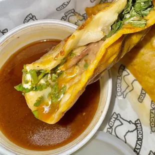 Quesabirria taco with birria sauce