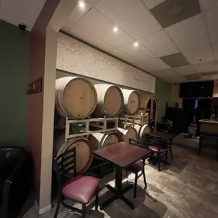 a row of wine barrels in a wine cellar