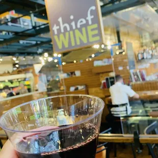 a hand holding a glass of wine