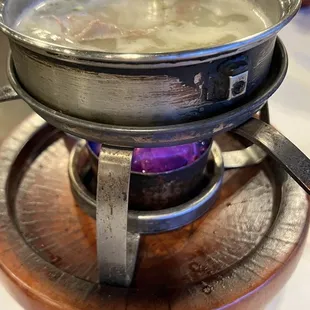 a pot of soup on a plate