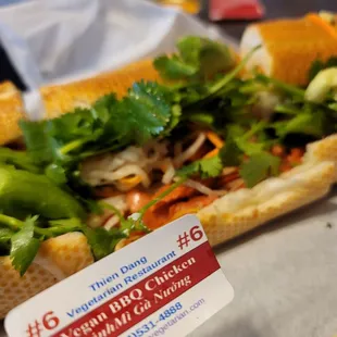 a hand holding a sandwich