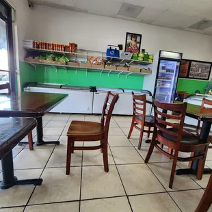 More seating. Facing the shelf of vegan jerky and frozen goods.