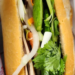 Half of a Banh Mi Cha Lua with add on of Ba chi (Vietnamese style pork ham sandwich with add on of pork belly).