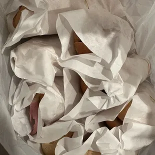 a sandwich wrapped in white paper