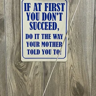 A sign behind the register.