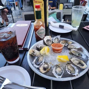 Oysters n the aftermath with nachos, burger, bread, cucumber salad n poster bar