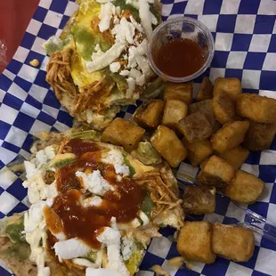 Tinga tostadas with fried egg, Mayo chipotle, queso fresco and sour cream.