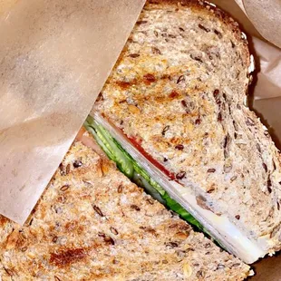 a sandwich in a brown paper bag