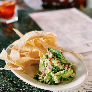 a plate of guacamole and chips