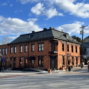 a brick building with a black roof
