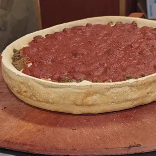 a large pizza on a wooden platter