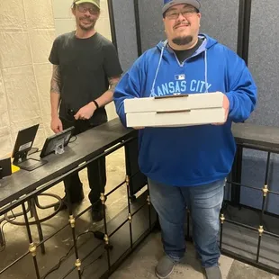 a man holding a pizza box